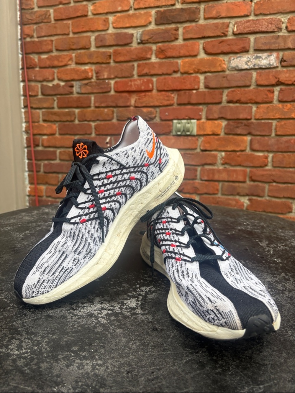 Nike White and Black Flyknit Running Shoe with Blue and Orange Accents